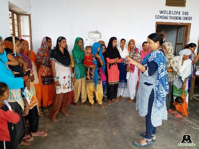 Rakhee Sharma leading a briefing with the women of the Kalandar community.